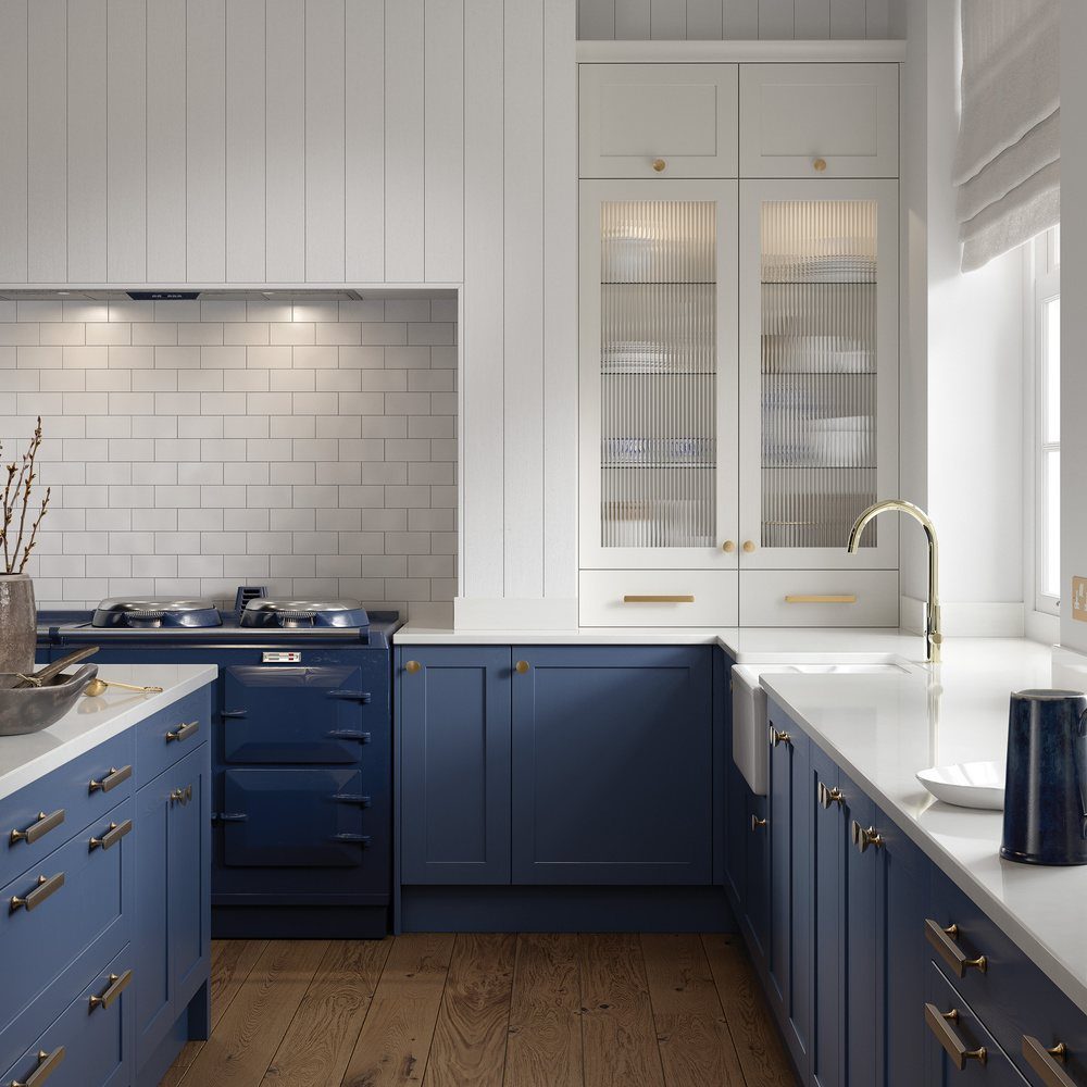 A navy shaker kitchen with brass ironmongery and a white worktop